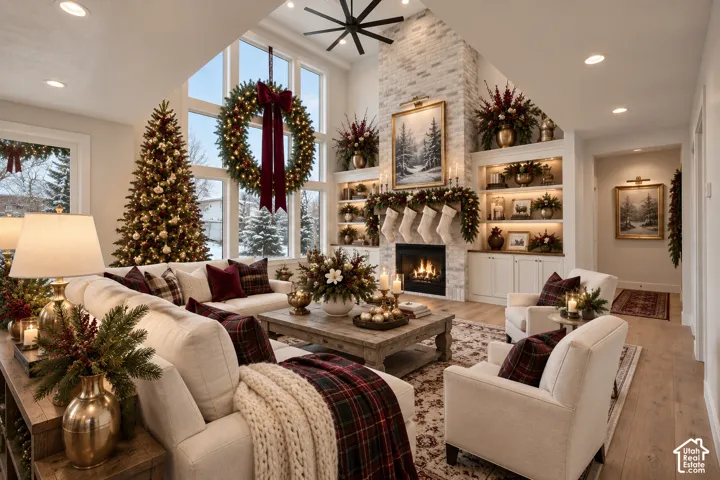 Vaulted ceilings with a ceiling fan, a fireplace with a light-colored brick surround, built-in shelving with integrated lighting, recessed lighting, and large windows