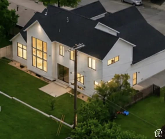 Modern exterior with white siding, black-framed windows, and a black shingle roof