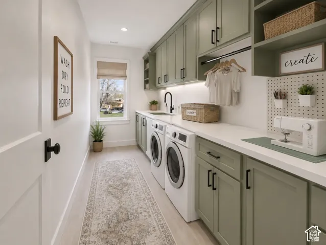 Spacious utility room featuring extensive built-in cabinetry, durable countertops, wood-finish flooring, and a large window