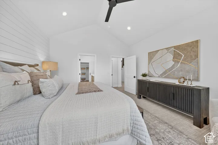 Vaulted ceiling, shiplap accent wall, recessed lighting, ceiling fan, and shaker-style doors