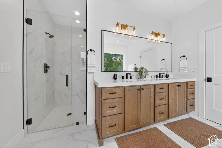 Expansive walk-in shower with a glass enclosure and a dark-toned shower fixture