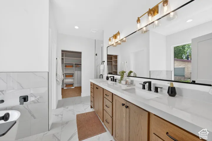 Dual vanity with wood-finish cabinetry and white countertops