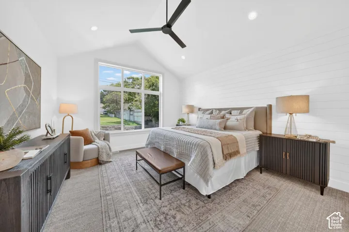 Vaulted ceiling with a ceiling fan, recessed lighting, large multi-pane window, and horizontal shiplap wall treatment