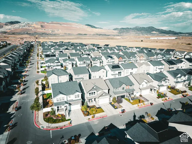 Residential community featuring multiple single-family homes, paved streets, and varied exterior finishes
