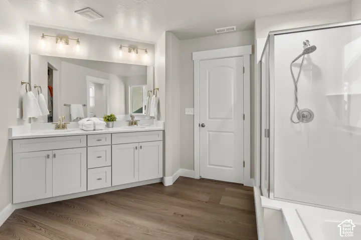 Dual vanity with light gray cabinetry and white countertops
