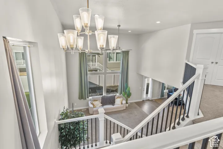 Two-story ceiling height with a contemporary chandelier and recessed lighting