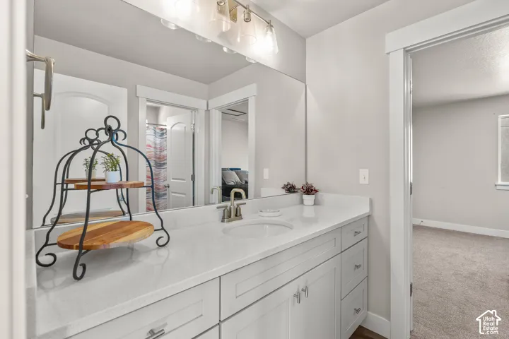 Vanity with an integrated sink, brushed nickel faucet, and a light-colored countertop