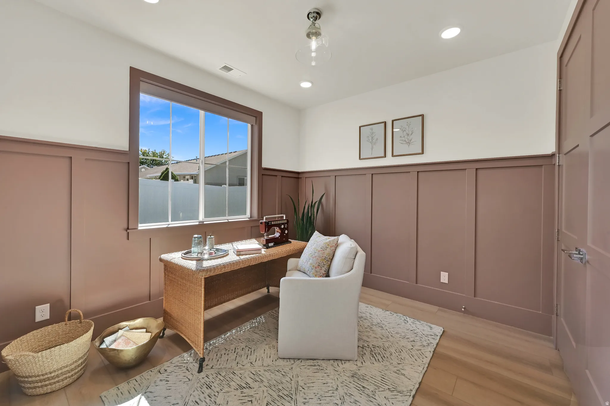 Board and batten wall paneling, recessed ceiling lighting, pendant light fixture, wood-finish flooring, and a large window