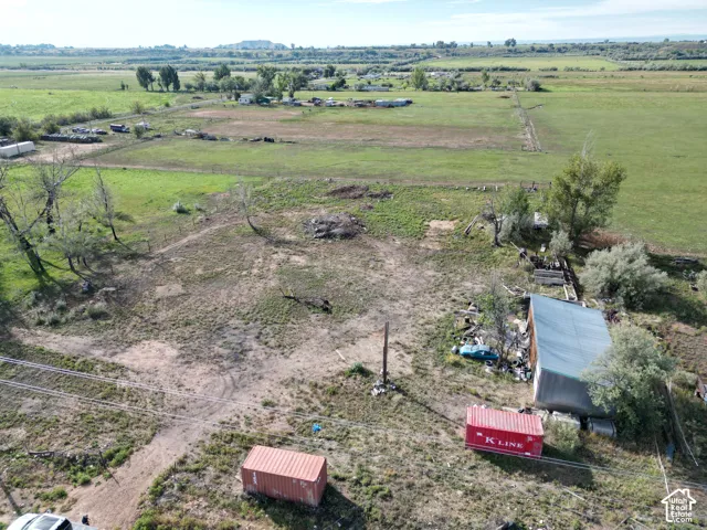 Expansive land parcel featuring a storage shed and open fields