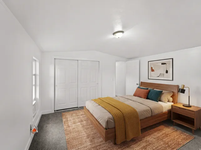 Recessed lighting, window with trim, white sliding closet doors, wall-mounted light fixture, carpeted flooring