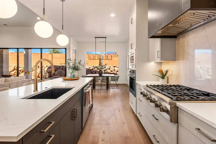 Gourmet kitchen featuring a gas range, built-in wall oven, and white countertops