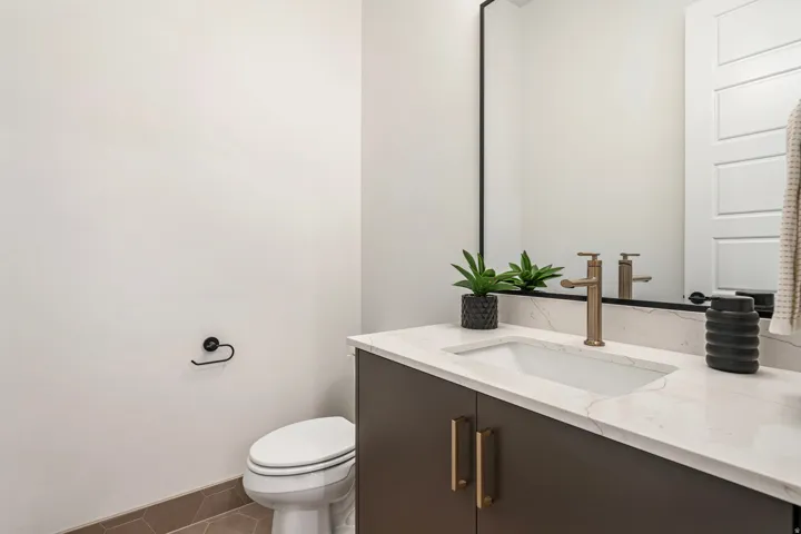 White rectangular undermount sink with a single-handle brass faucet
