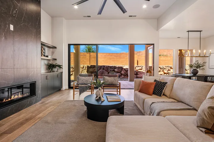 Contemporary fireplace with a dark-toned surround, wood-finish flooring, and recessed lighting