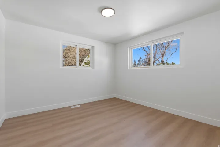 Recessed lighting, light wood-finish flooring, and two windows