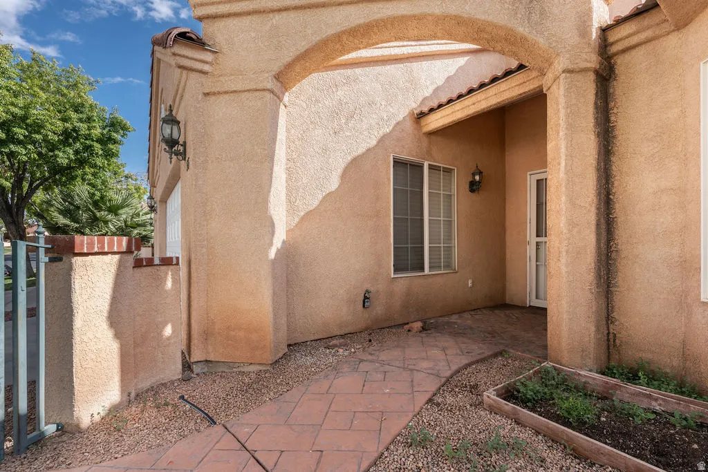 Stucco exterior with arched entryway