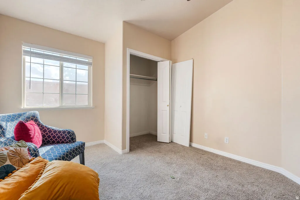 Neutral-toned walls complement the window with horizontal blinds