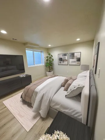Recessed ceiling lighting, wood-finish flooring, a window with horizontal blinds, and a built-in media console
