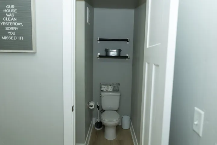 Half bathroom with wood floating shelves