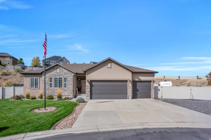 Stone and stucco exterior with a two-car garage