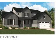 Two-story exterior with dark gray siding and board-and-batten accents
