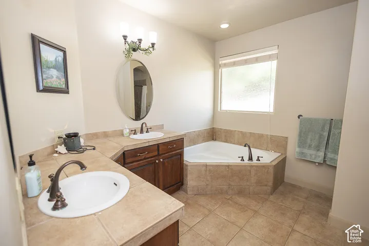 Dual vanity featuring undermount sinks and dark wood-finish cabinetry