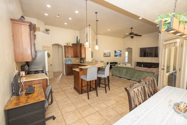Kitchen featuring wood cabinetry, granite countertops, and tile flooring