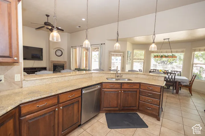 Kitchen featuring a large island with an undermount sink, granite countertops, and wood cabinetry