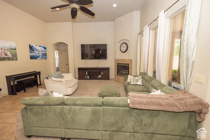 Vaulted ceilings, a built-in fireplace with a stone surround, and large glass doors