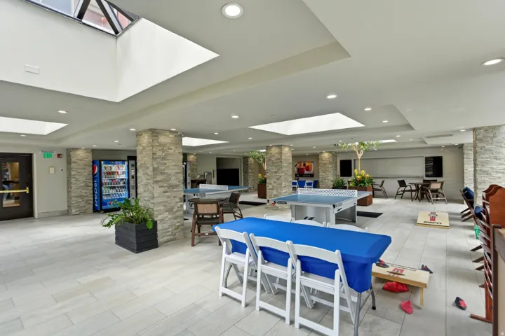 Spacious common area featuring multiple skylights, recessed lighting, and tile flooring