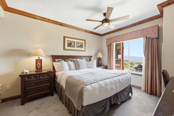 Window with mountain backdrop, wood-finish ceiling fan, recessed ceiling, wood-finish trim, built-in window valance