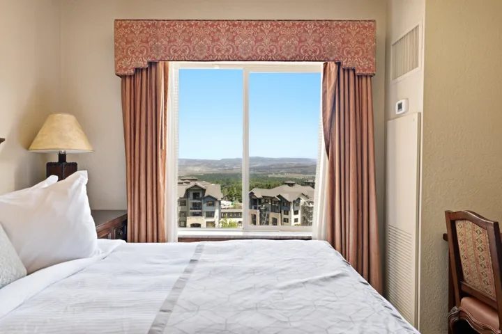 Expansive window with decorative valance and full-length drapes