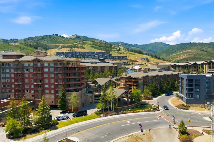 Mountainous landscape featuring multiple multi-story residential buildings and paved roadways