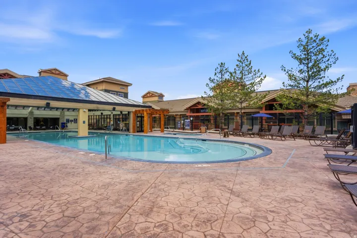 Expansive outdoor pool with a surrounding patterned concrete deck