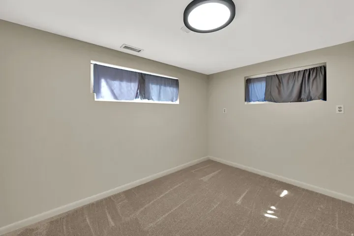 Recessed windows, neutral wall tones, and installed ceiling lighting