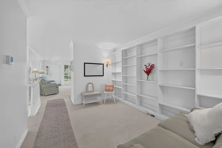 Expansive built-in shelving, crown molding, and neutral wall paint