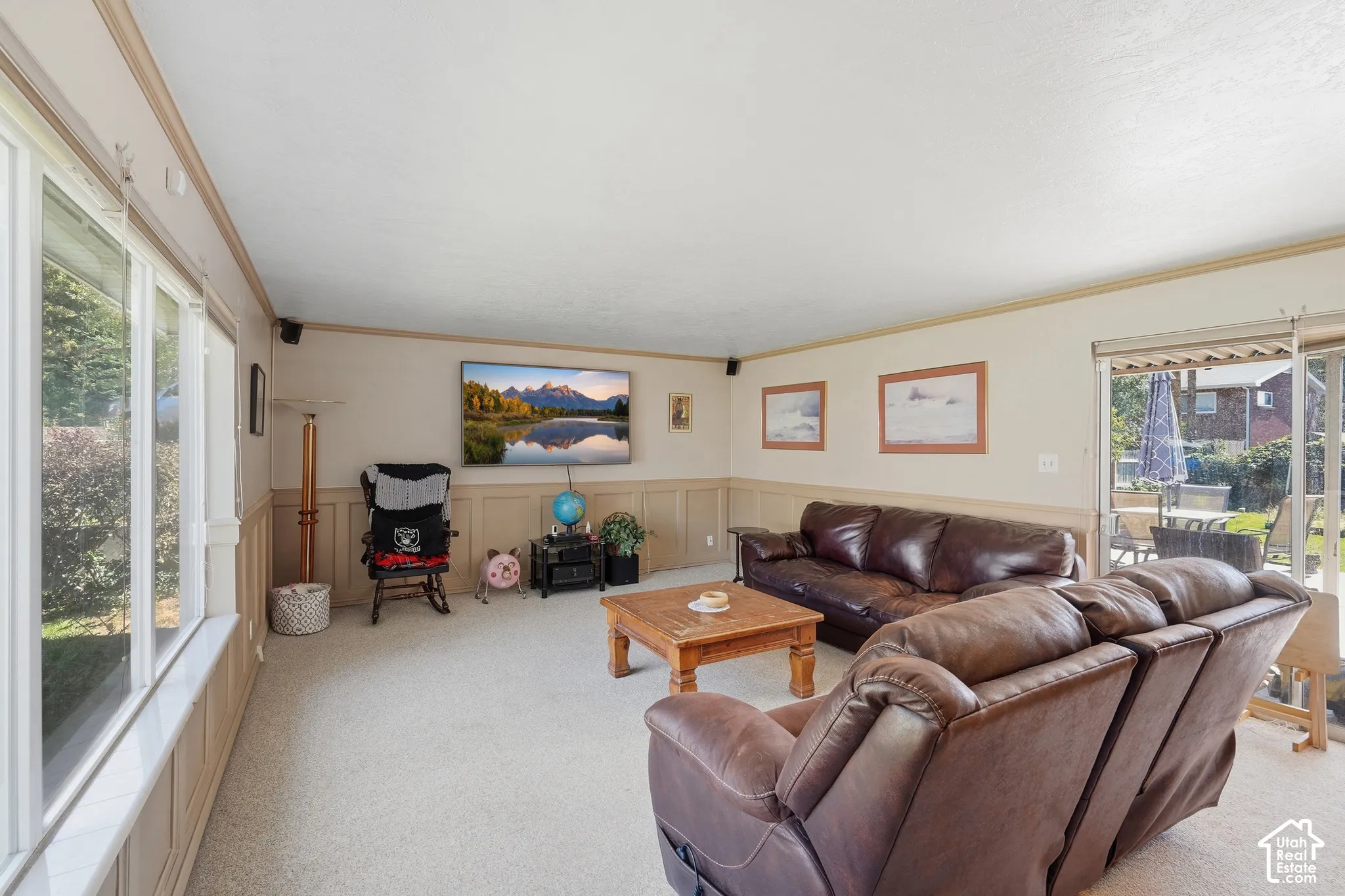 Living room with carpet and large windows.