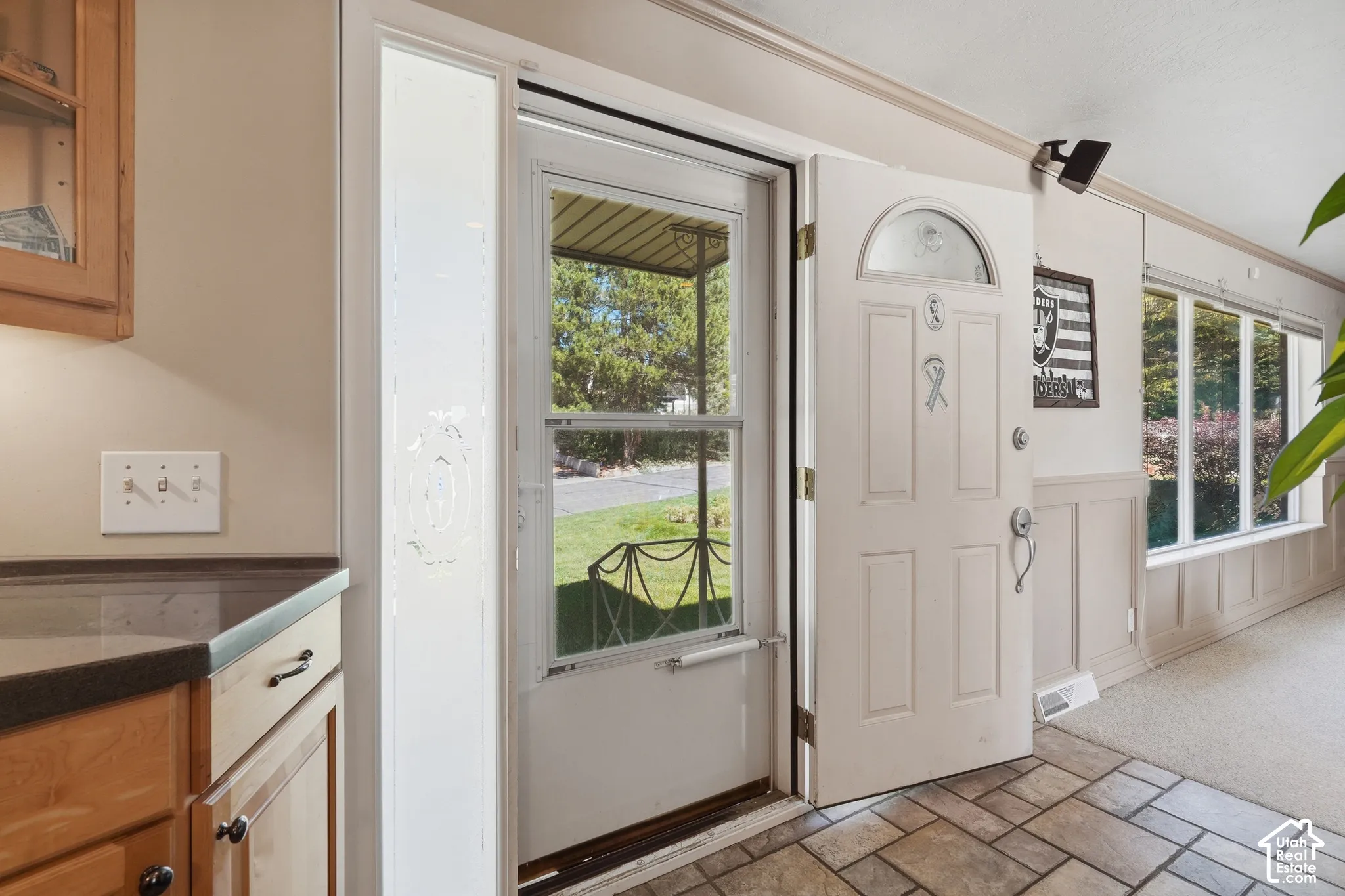 Entryway with storm door.  Enters into kitchen and front room.