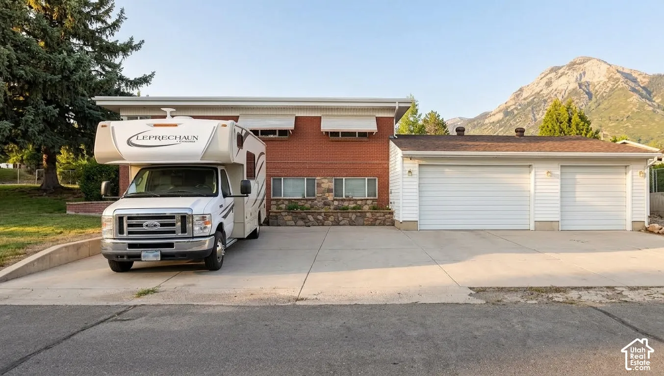 Oversized 3 Car Garage with RV Parking on the side of the home, with a basement entrance.