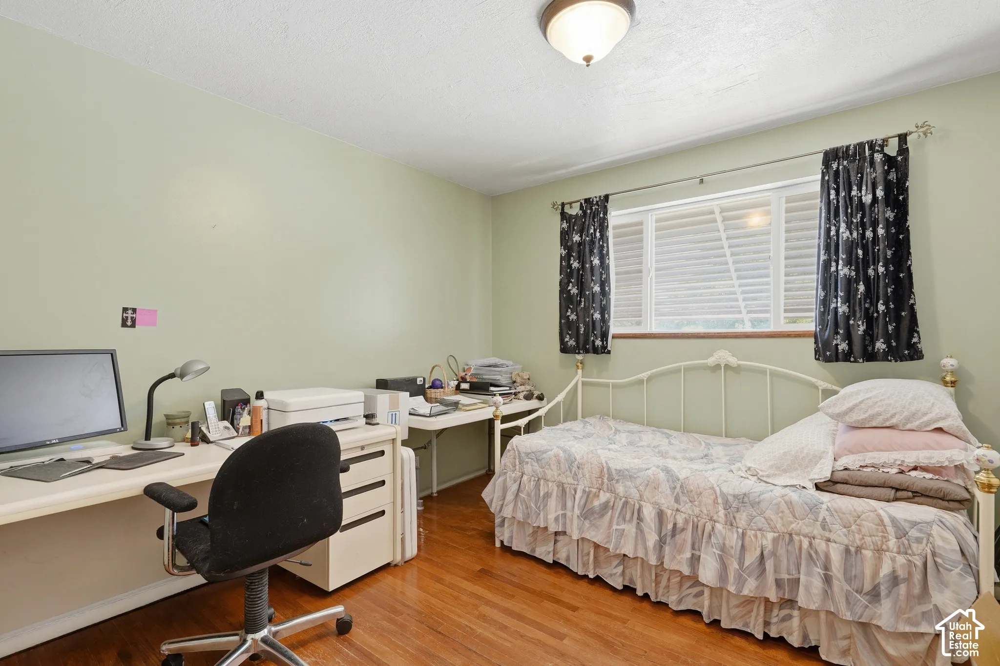 Spare bedroom on main level with original hardwood floors.