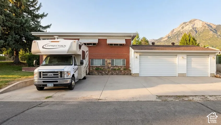 Oversized 3 Car Garage with RV Parking on the side of the home, with a basement entrance.