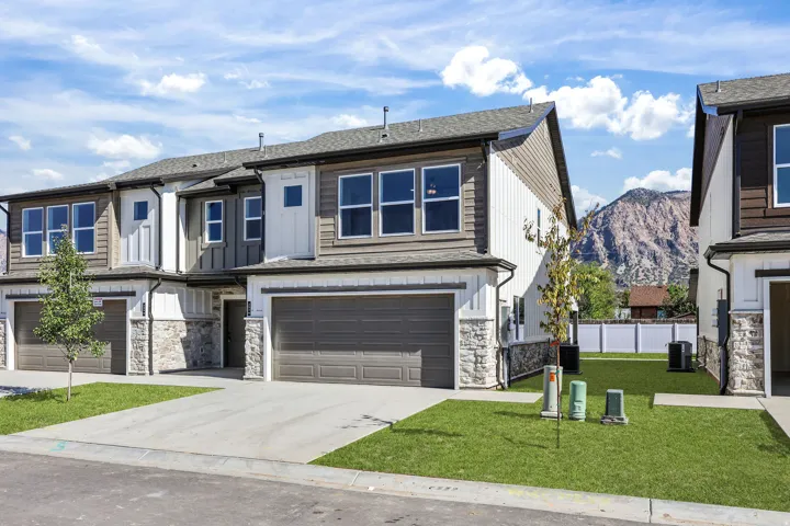 Modern townhome exteriors featuring varied siding, stone accents, and attached garages