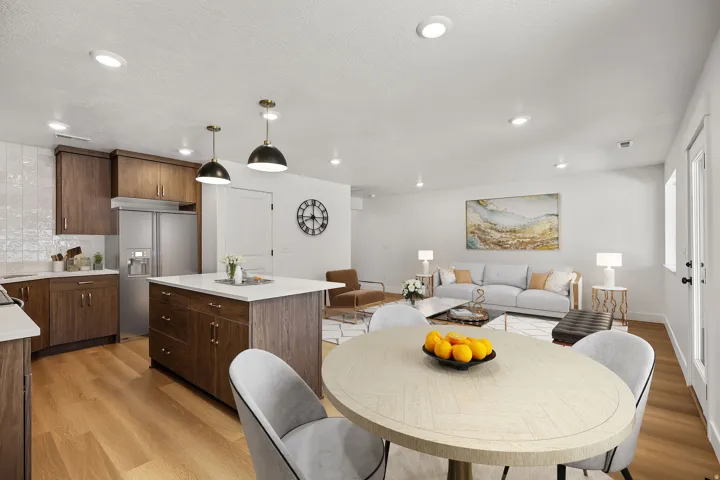 Open-concept layout featuring wood-finish flooring, recessed lighting, and a kitchen island with pendant lighting