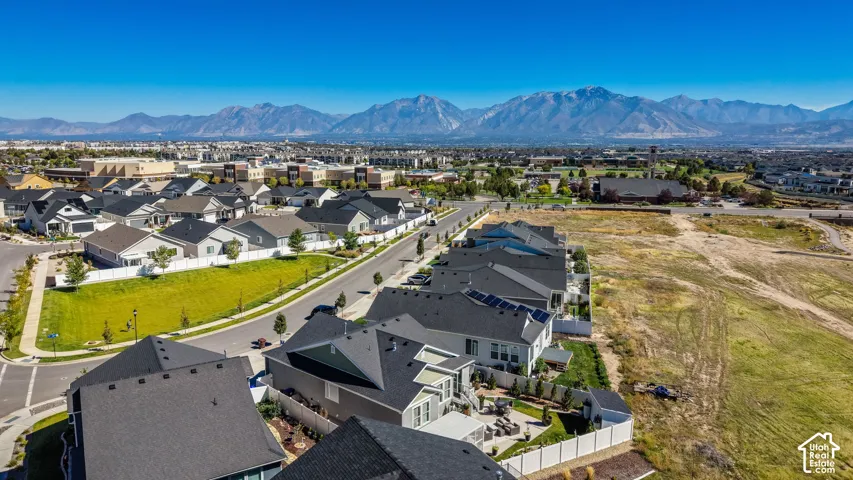 Residential development featuring modern homes, paved streets, and mountain scenery