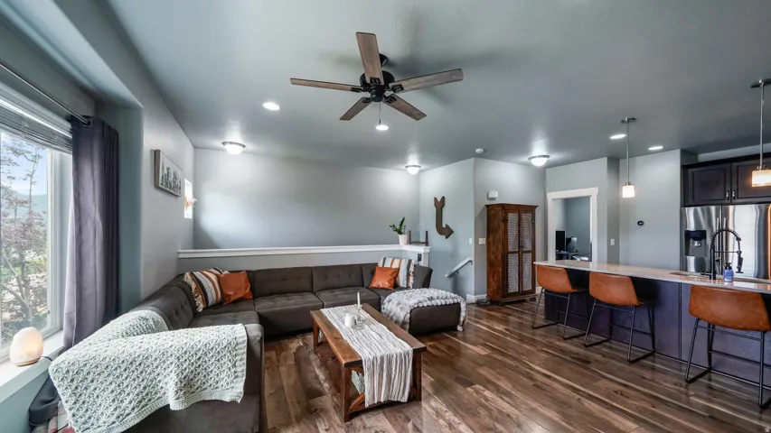 Open concept living space with wood-finish flooring, recessed lighting, and a ceiling fan