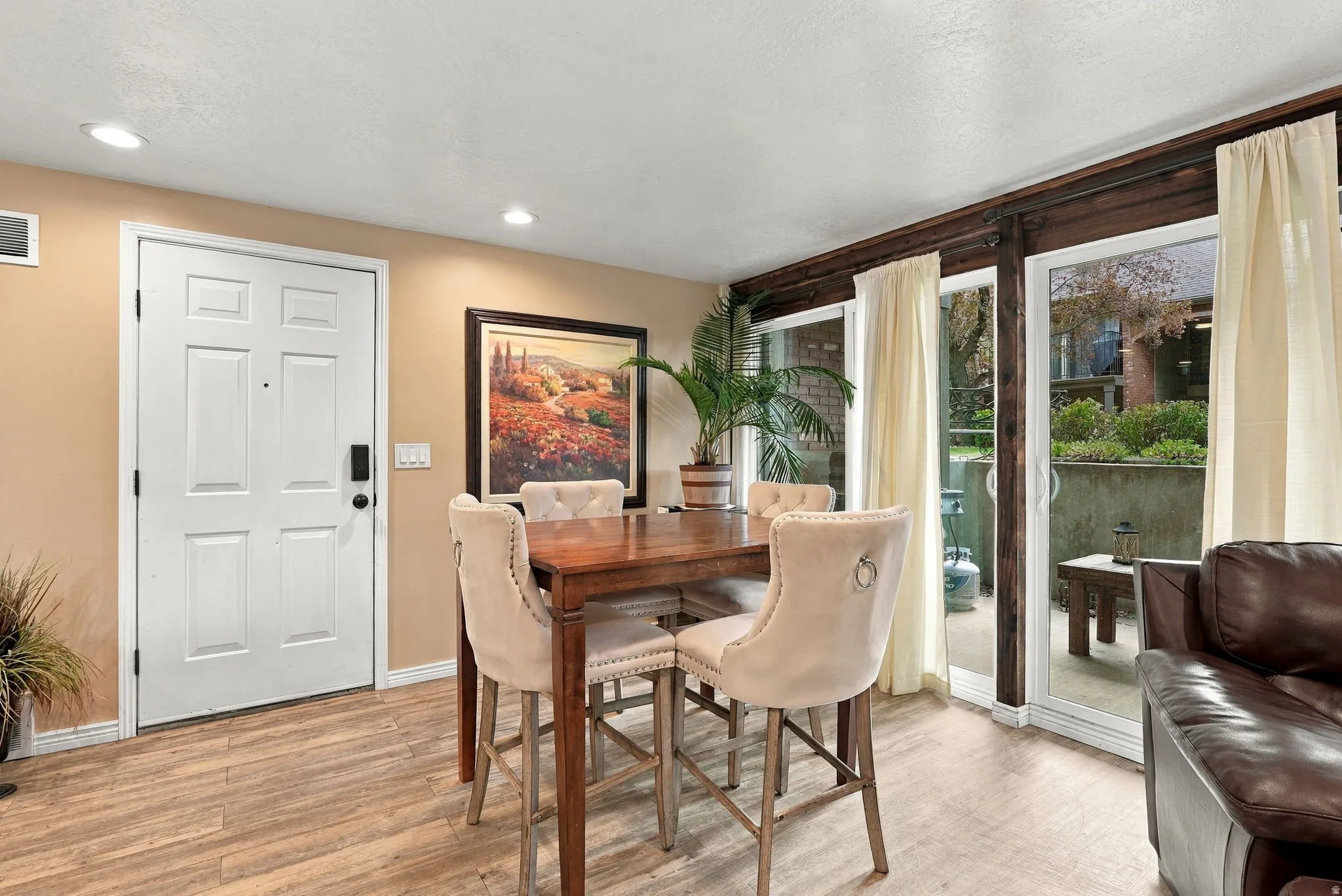 Wood-finish flooring, recessed lighting, and a paneled entry door