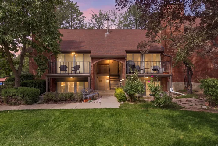 Brick exterior with a brown roof and multiple balconies