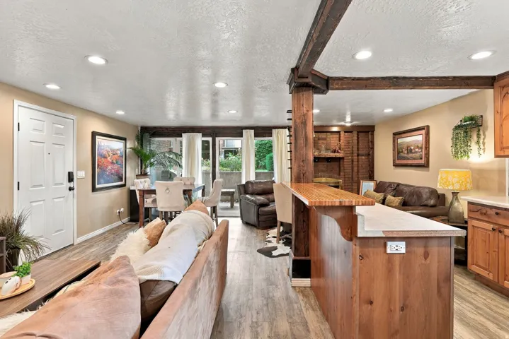 Recessed lighting, wood-finish flooring, wood cabinetry, built-in breakfast bar, and French doors