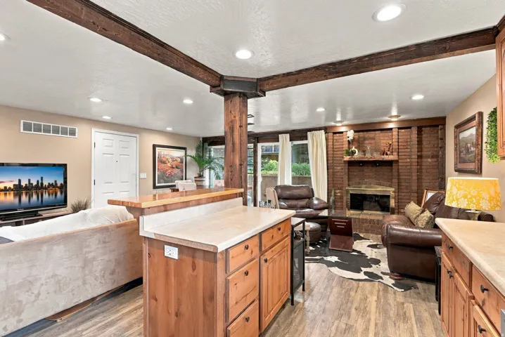 Kitchen island with light-toned countertop and wood cabinetry
