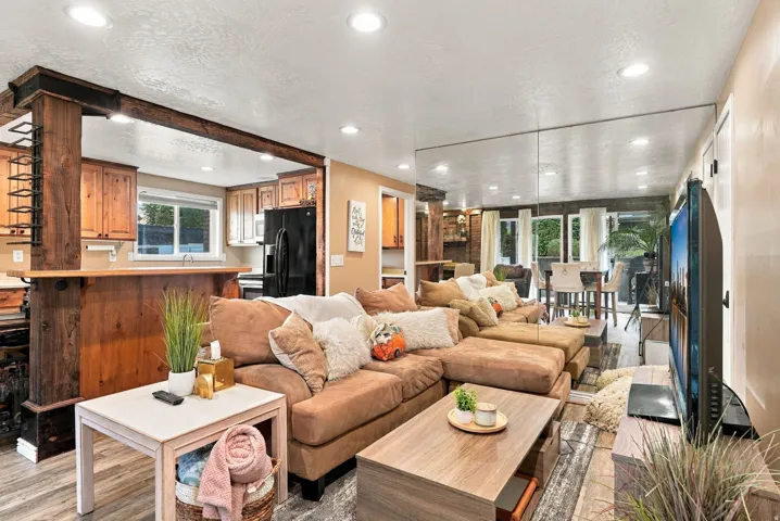 Open-concept living area featuring recessed lighting and wood-finish flooring