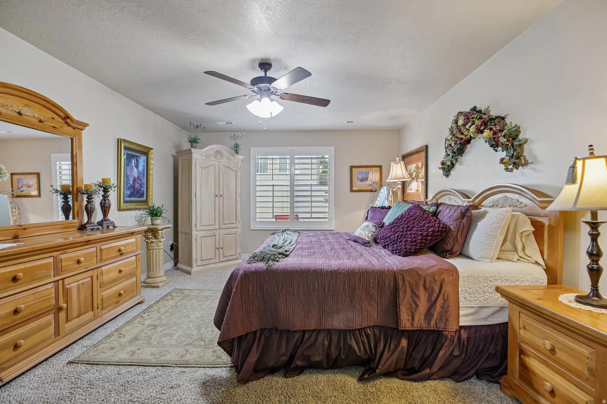 Carpet flooring, ceiling fan with integrated lighting, window with plantation shutters, vaulted ceiling, and built-in closet